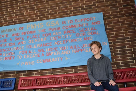Freshman Quinn Licata sits in front of the mission statement for West Highs GSA.