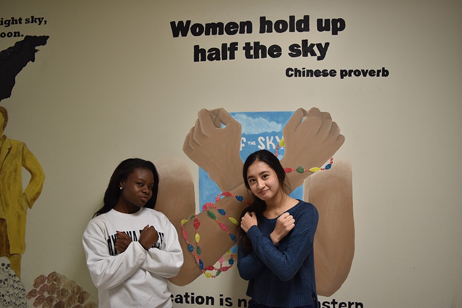 Junior Alyssa Jackson, a Women of West Executive Board member, and freshman Maddie Cooke, a Feminist Club member, pose in the history hallway.