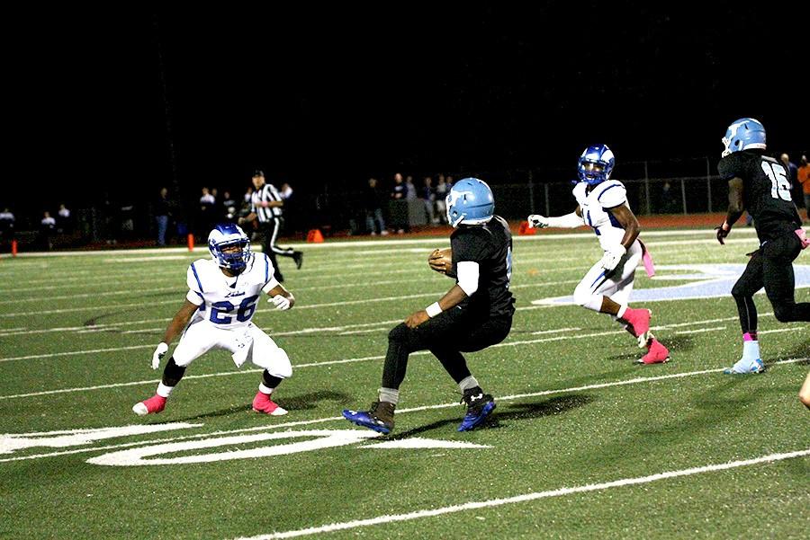 Senior running back Nick Lewis shakes off a defender at home against Ladue on Oct. 2. 