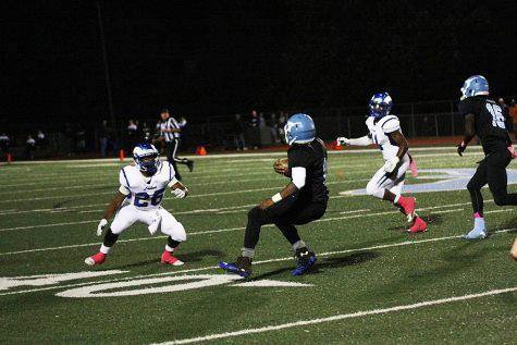 Senior running back Nick Lewis shakes off a defender against Ladue on Oct. 2 at home. 