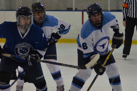 Seniors Jacob Ransom and Hasan Baig battle for the face-off against a Duchesne forward.