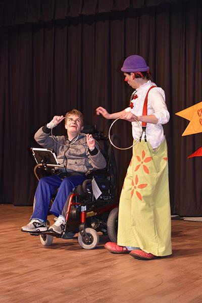 Holding the rings, senior plus Adam Selm helps Claire the Clown with the magic portion of the show. I thought it was great because all of the kids who usually cannot participate in things here were able to do something during the performance or workshop, so this was something completely designed for them, Special Education teacher Jamie Kopp said.