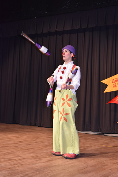 Juggling props, Claire Wedemeyer, or Claire the Clown, performs as part of Circus Flora and the Community Outreach Program Clowns on Call. Circus Flora is a St. Louis based circus that has a big show in the summertime and its incredible, Wedemeyer said.
