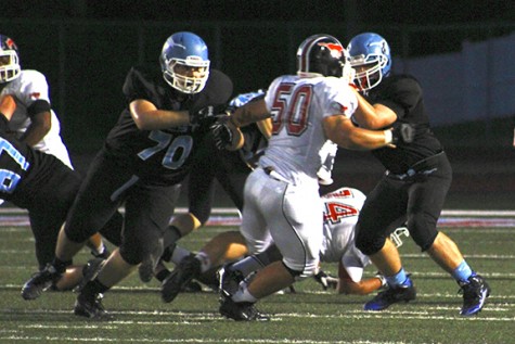 In a home game versus Parkway Central, senior Brian Loomis blocks for a run.
