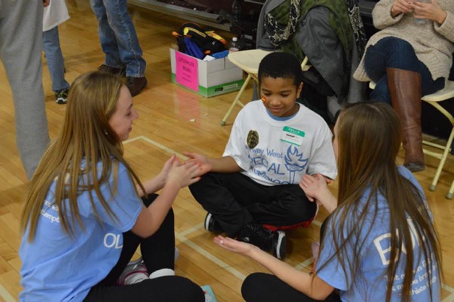 Sophomore Emma Moss takes on the job of buddy and plays with her athlete at Special Olympics.