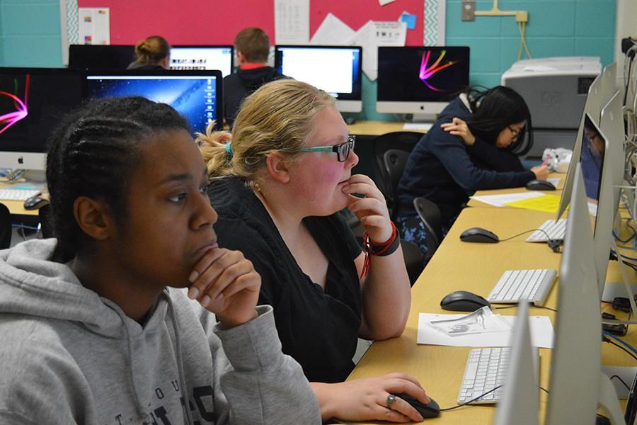 Reflections members work in the journalism classroom to design the pages of the book.