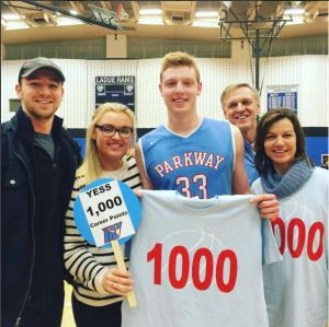 Senior Wyatt Yess celebrates with his family after he scored his 1000th point at the Varsity basketball game against Ladue.