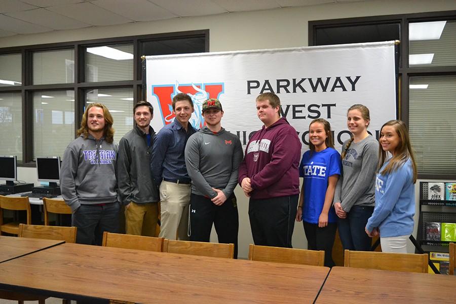 Students pose together after signing with their future college.