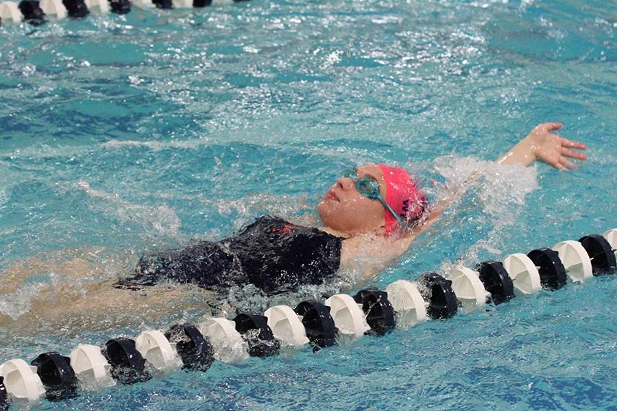 Senior Gabi Vieira swims backstroke at the Parkway Quad Swim meet on Jan. 8 at Parkway North.