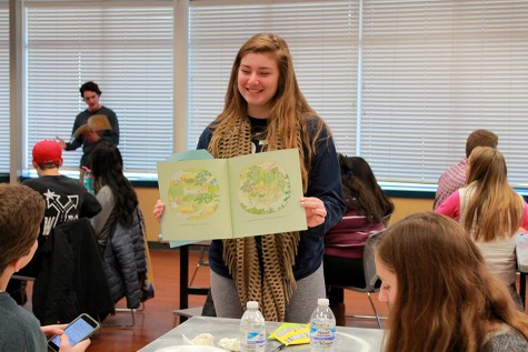 Reading from a picture book, senior Andrea Gordon presents the lesson to her group.