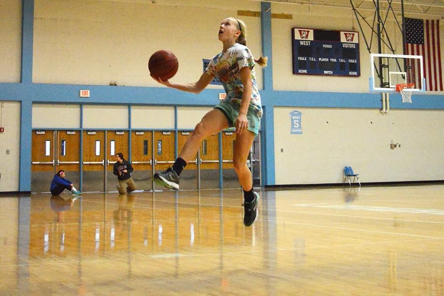 Going in for a layup, freshman Tess Allgeyer makes the shot.