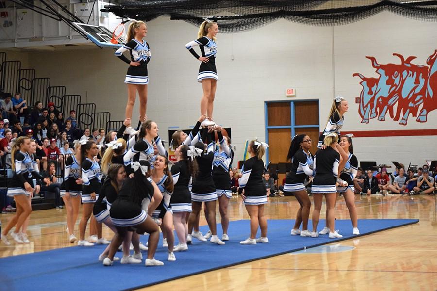 West’s Cheerleading squad performs a pyramid for the student body. The cheerleaders spent several late nights perfecting the performance. “It was a little nerve-racking being at the top since I didn’t want to mess it up in front of the whole school or ruin it for the team,” freshman and flyer Sophie Pellegrino said. The cheerleading squad also performed in the fall pep rally.

