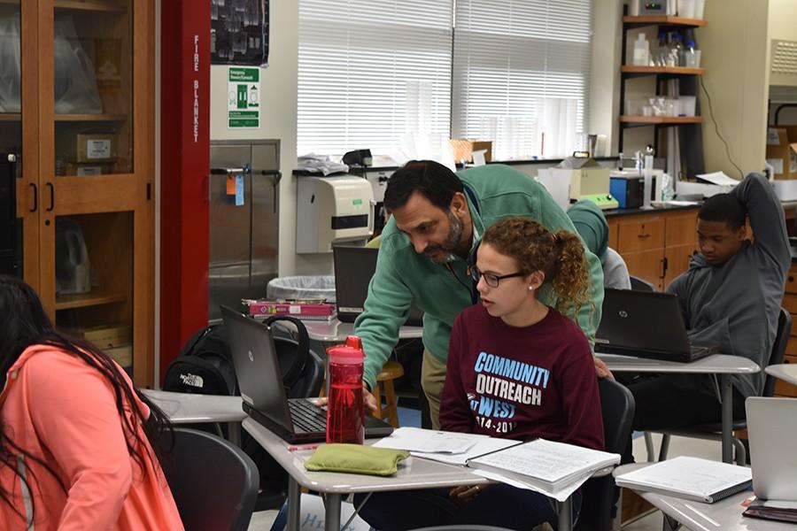 Azar helps Junior Maggie Morse during his Honors Biotechnical Engineering class