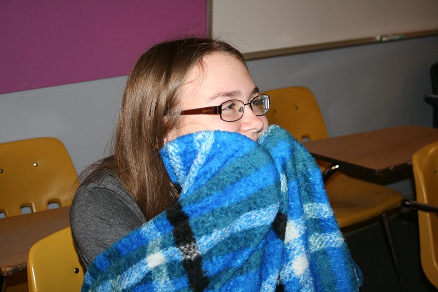Freshman Meghan Stanfield sits in English class, wrapped in a blanket. I was really excited for the lock-in, because I heard there was going to be a magician. It really stinks that it got cancelled, I was looking forward to staying up all night and eating pizza, Stanfield said.