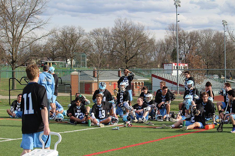 The boys lacrosse team huddles together after the first half versus Chaminade to discuss what to work on to beat the opponent.