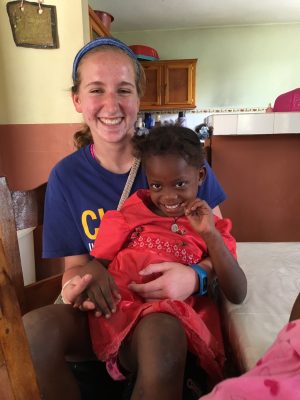 Allgeyer holds a child in her lap on her mission trip to Haiti.