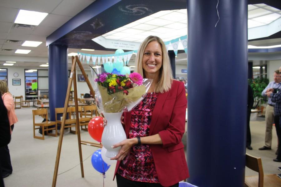 Middendorf holds a flower bouquet from staff.