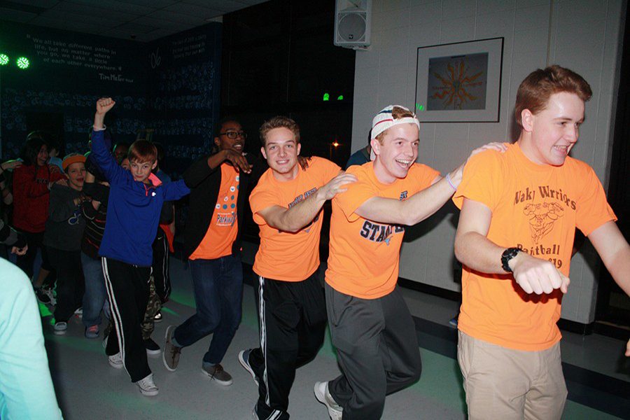 Juniors Joe Fuller, Jeff Arnell and Judson Martin lead a canga line at a Safe Drug Free sponsored middle school mixer on Jan. 20.