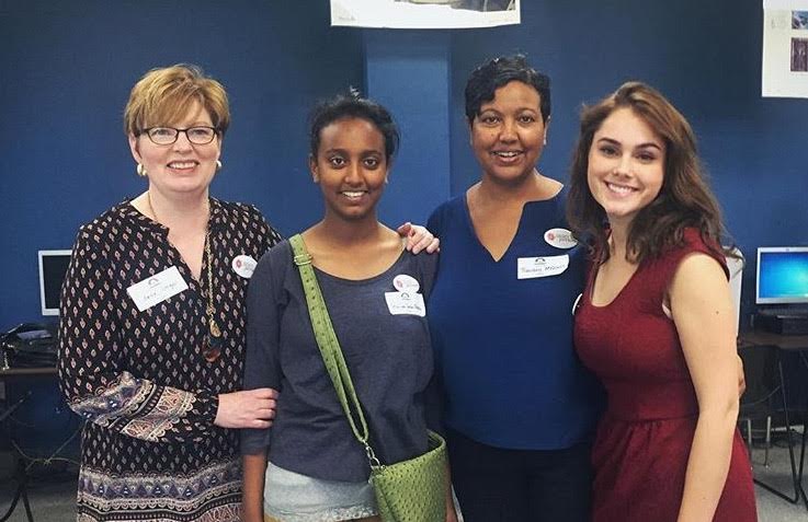 Dignity Period administrator Jane Unger, Mariam Seba, Freweini Mebrahtu and senior Mariel McMindes pose for a picture after Mebrahtu’s speech.