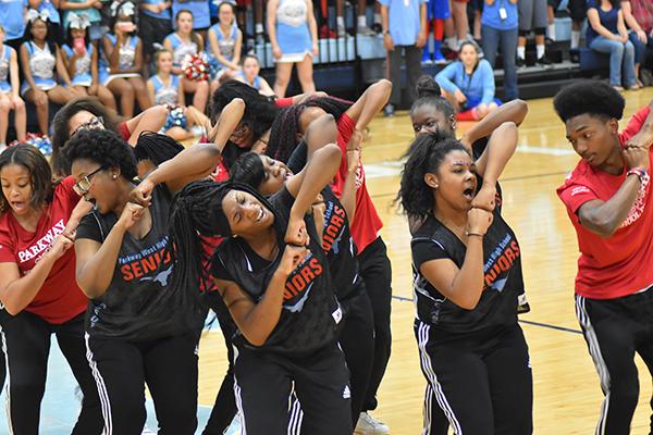 The step team performs at the homecoming pep rally.