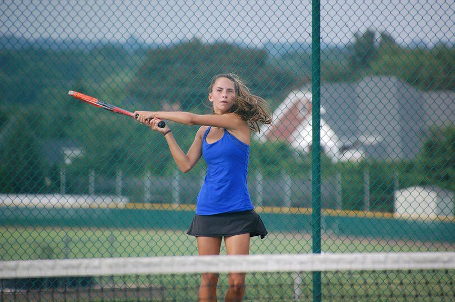 Swinging her racket, freshman Charlotte Zera plays in a singles match against Lafayette at home on Wednesday, Aug. 31.