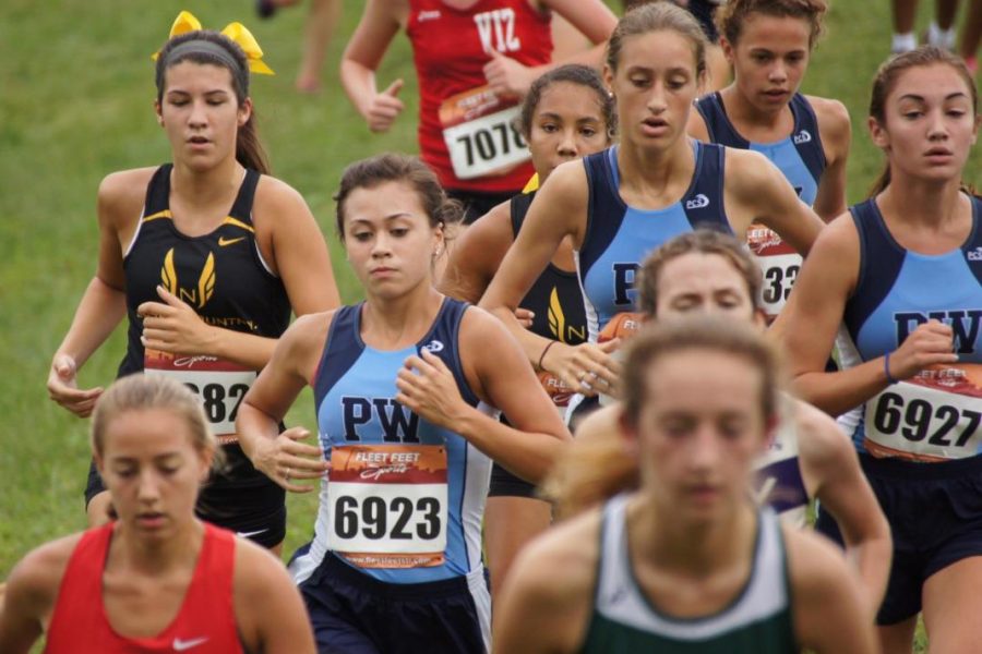 Racing together in a pack, the varsity team competes at the Hancock Invitational.