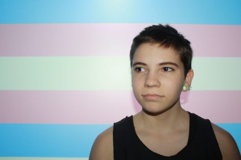 Morse stands in front of the international transgender flag. "There are a lot of people in this school and in a lot of places that don’t like me," Morse said. "There are people that just don’t understand it, but if you don’t understand it, it isn’t an excuse to be mean to people."