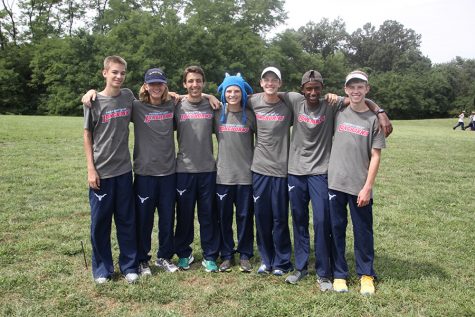 The varsity boy's team poses after winning the Parkway Quad. Junior Blake Selm (center) wears 2016 graduate Logan Stucki's blue hat, which is traditionally reserved for the team's number one runner in each race.