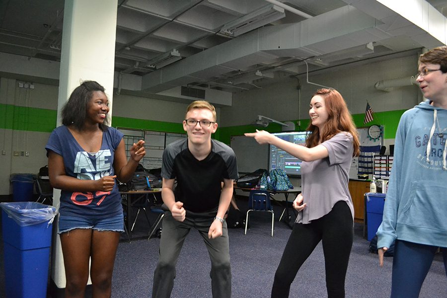 Playing an improv game, juniors Kayla Bell, Kennedy Brown, Hayden Riehl and Ann Truka act out a scene at an after school improv session.