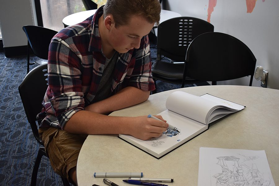 Junior Zach Whistle draws in his sketchbook whenever he gets free time.