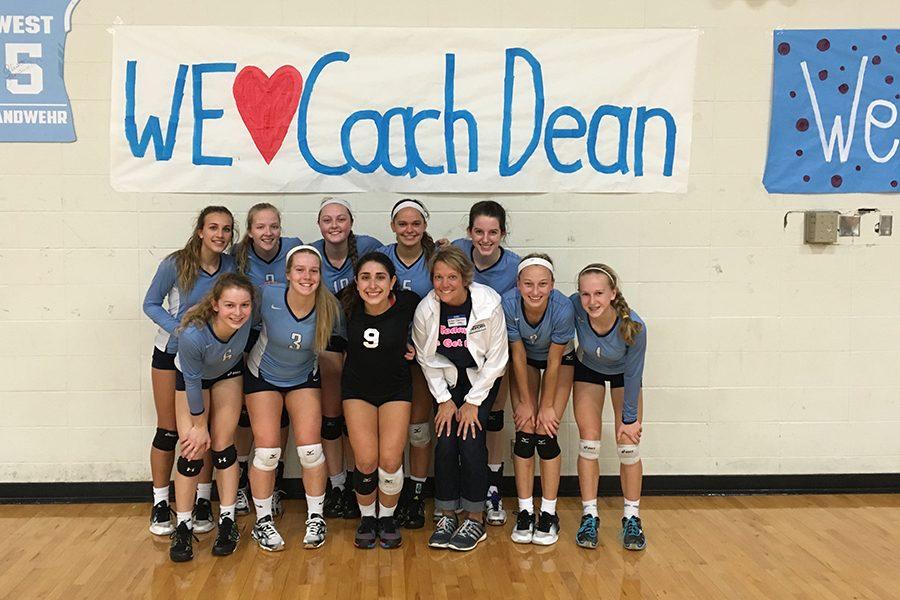 Coach Susan Dean stands with the varsity team on Alumni Night after winning two sets against Parkway South.