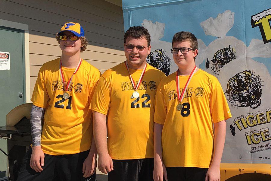 Seniors Kjell Hagen and Tyler Hannegan, and eight grader Kia Hagen wear gold medals after their game against Cape Girardeau.