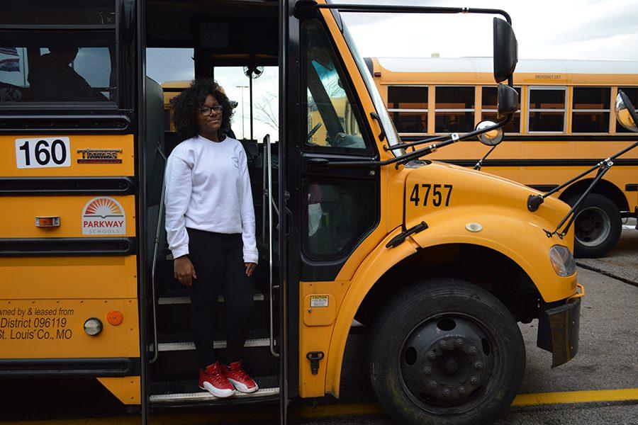 Brooks stands in the doorway of the bus where she helped call an ambulance for a student in distress.