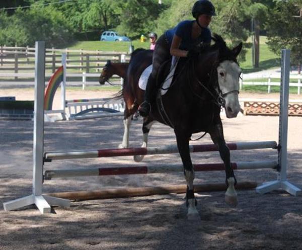 Sophomore Karly Tyree and her horse, DJ, warming up over a practice fence.