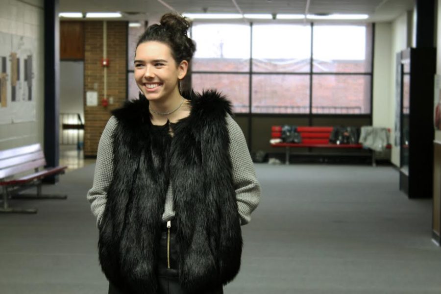 A statement piece like this black fur vest from TopShop can serve to pull an upscale outfit together.