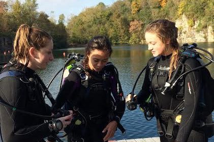 Senior Anna Mae Atkins, junior Emily Dickson, and sophomore Hayden Sampson check their gear after the last dive at Mermet Springs.