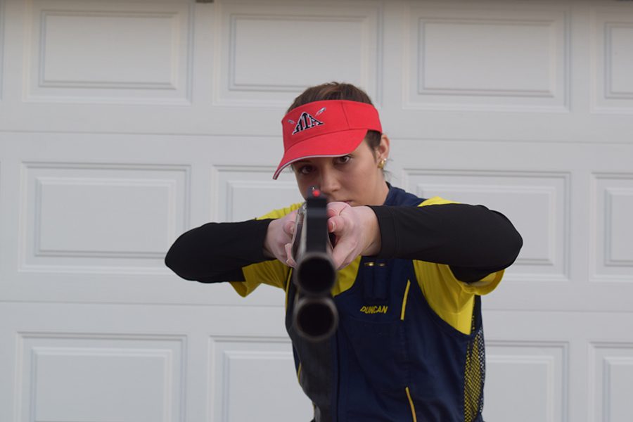 Senior Duncan Mcbride aiming with her double barrel shotgun.