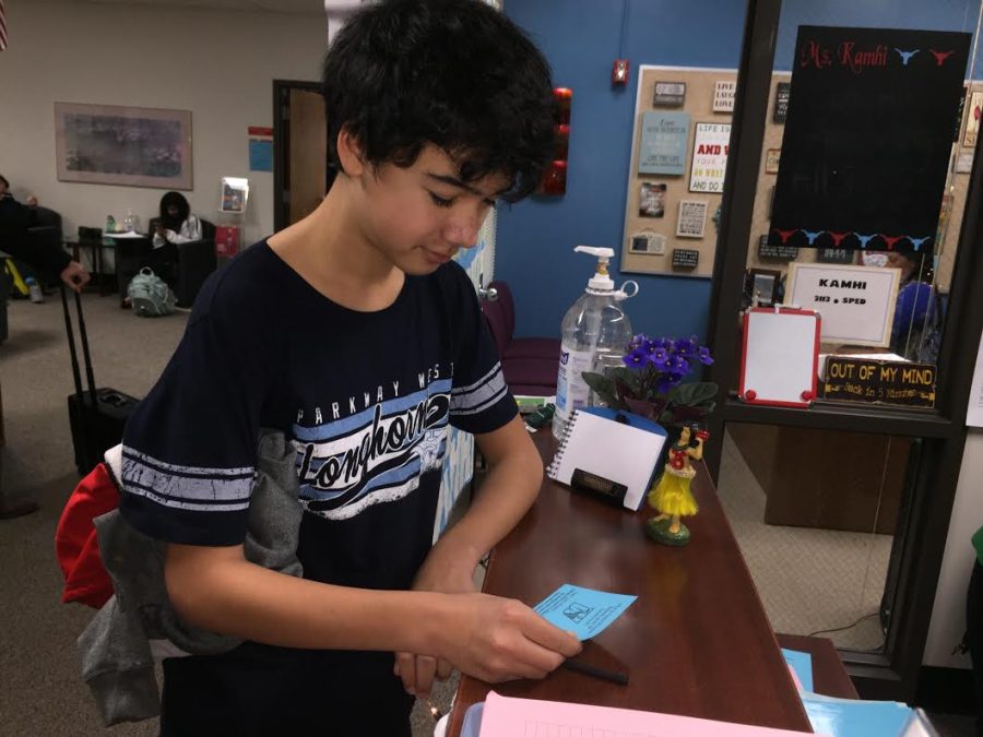 To prepare for the AP fair, freshman Nate Kronert picks up his pass in counseling. 