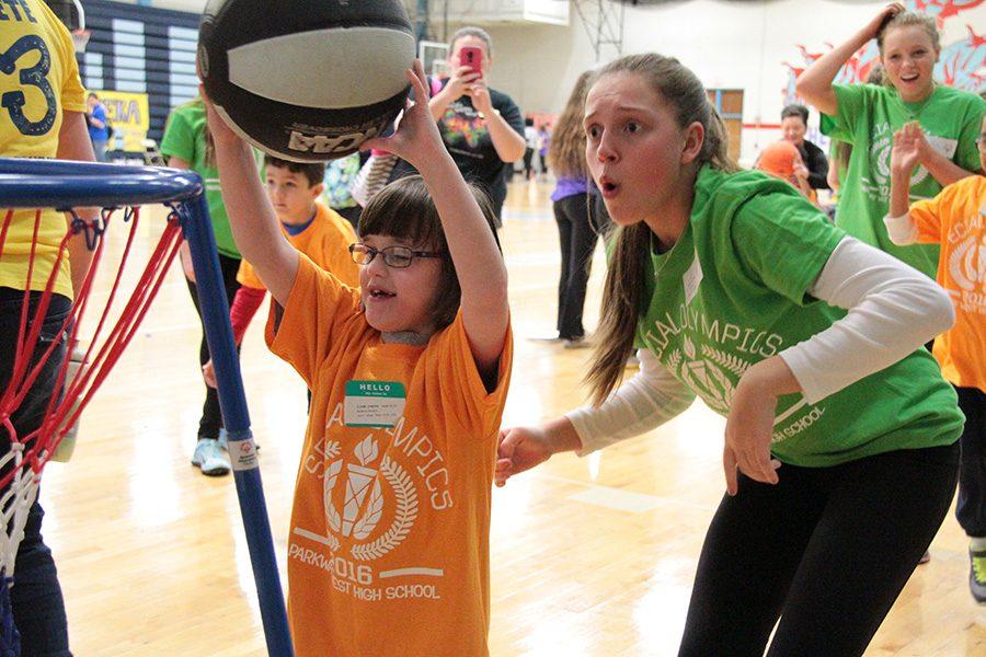 Cheering on her buddy, senior Julia DeFrank watches as her athlete shoots the basket.  She enjoyed the day, and that was awesome because they said last year she was nervous to even go into the gym, DeFrank said.