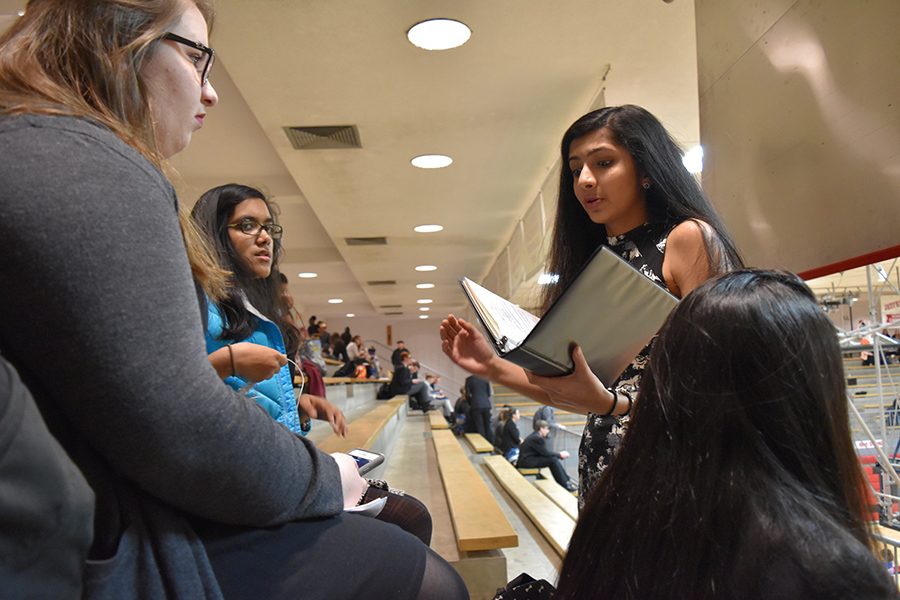 Practicing for her poetry event at the Jefferson City Invitational, held Jan. 28 through 29, junior Khushali Sarnot recites her piece to sophomores Kristina Humphrey and Nina Maitra.