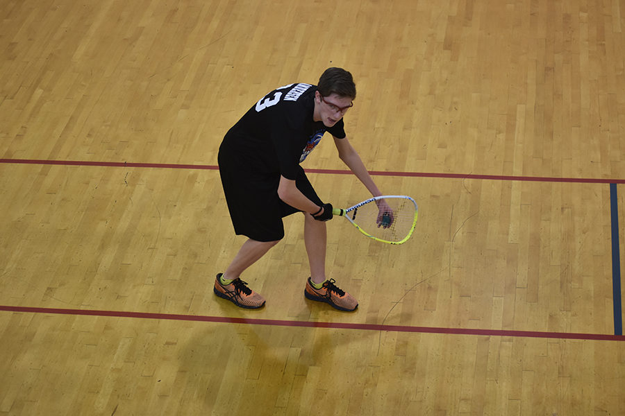 Junior Kyle Andersen crouches in preparation to serve the ball. Andersen has participated in the team for three years.