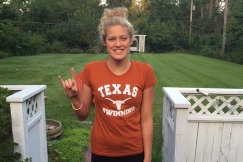 Putting up the Texas Longhorns hand sign, senior Evie Pfeifer poses for her commitment to University of Texas at Austin. 