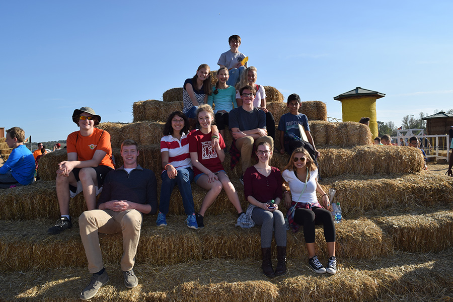 Sitting on hay stacks, the Best Buddies club poses for a picture at Match of the Patch.