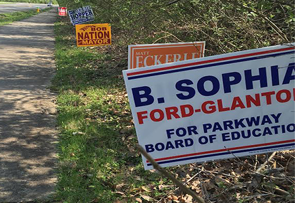 Campaign signs for the upcoming Parkway school board election pile up along the side of Baxter road.