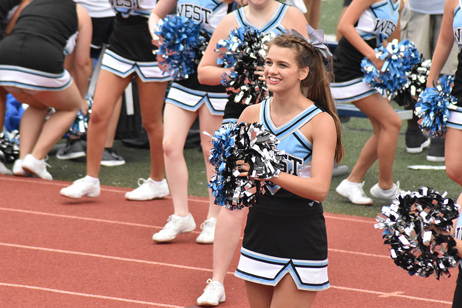Kristen Baranski cheers for the football players alongside the rest of her team at a varsity game. 