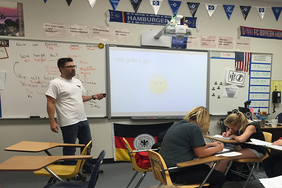 German teacher Michael Kloster teaches his first hour German I class a lesson on verb conjugation.
