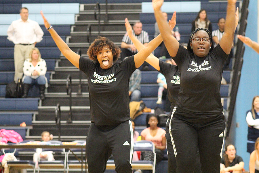 Arms thrown up in the air, junior Donielle Coach makes facial gestures to entertain the audience as she steps in the gym. “I love showing who I am in stepping by making faces to express my emotion at that moment in time,” Coach said.

