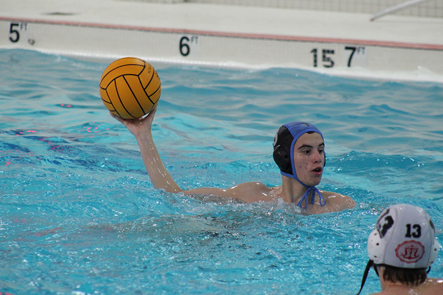 Looking for someone to pass to, sophomore Zaide Johnson prepares to throw the ball.