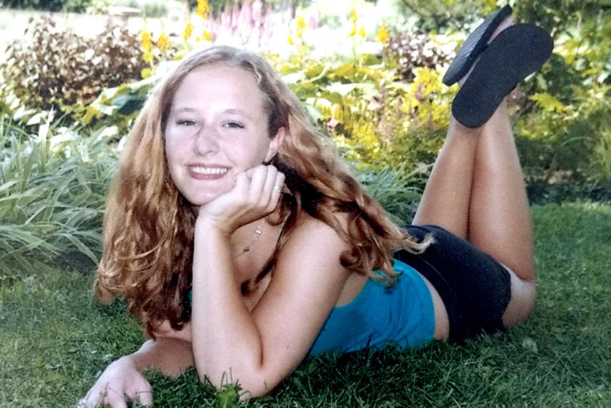 Privett poses in a garden for her senior pictures.