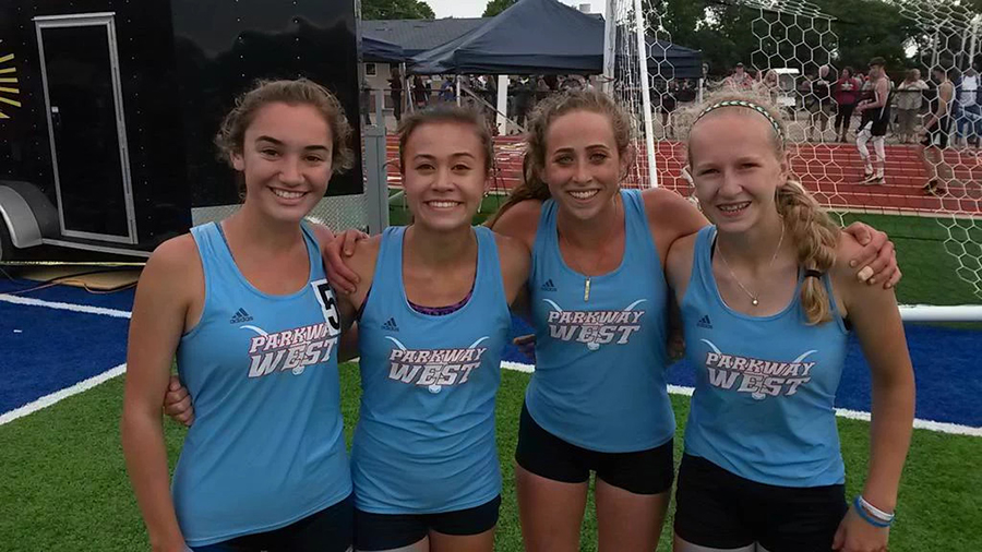 Sophomore Chloe Hershenow, junior Emily Dickson, and sophomores Natalie Butler and Tess Allgeyer celebrate after finishing first in the 4x800 meter relay at sectionals on May 22. 